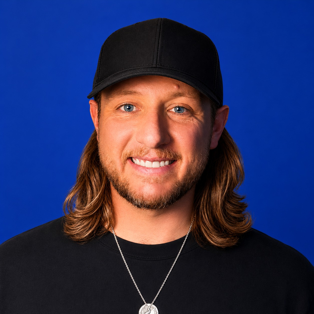Adam Bezemek headshot with a blue background.